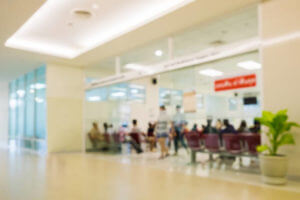 Blurred scene sliding glass in hospital,many people waiting treatment