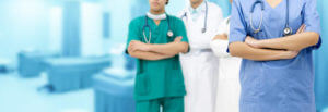 Medical team staff - General practitioner doctor, surgical doctor and nurse standing in hospital office. Healthcare business and doctor service.